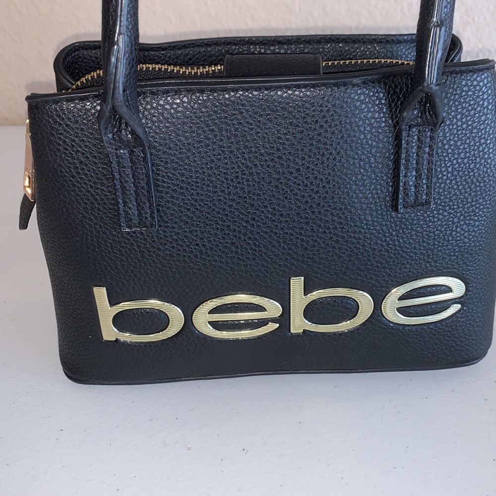 Bebe mini black and gold purse.